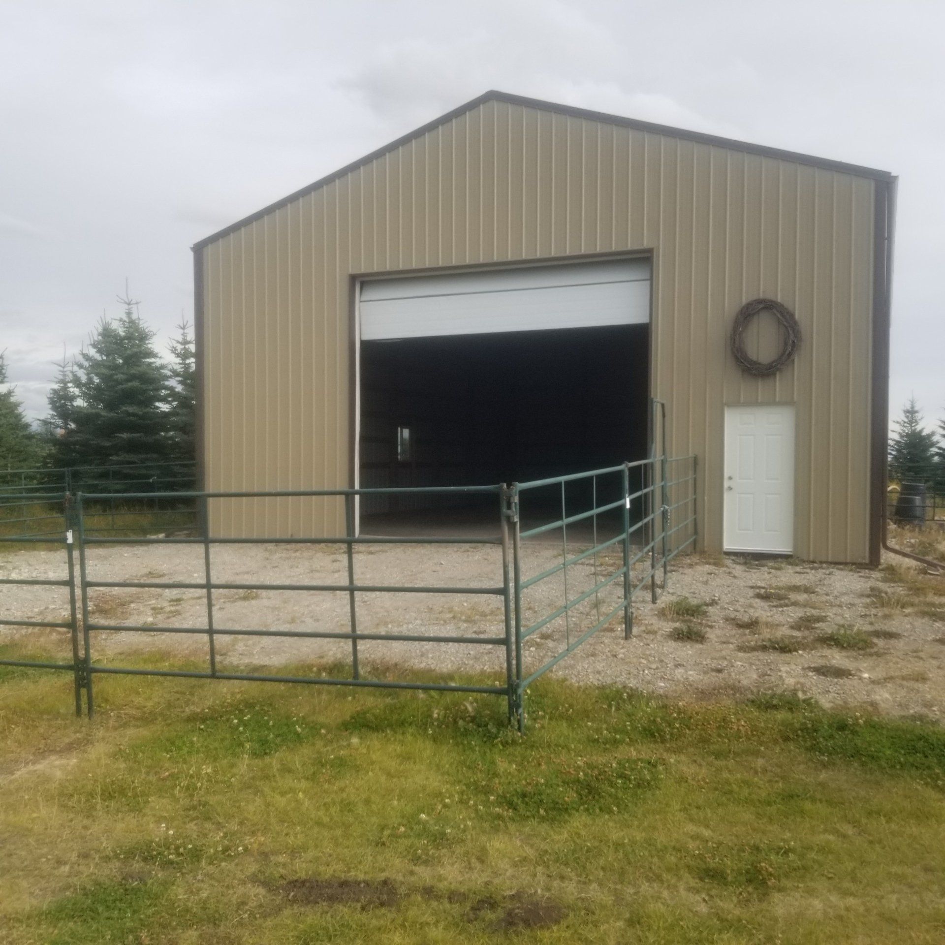 A large building with a large door and a fence around it