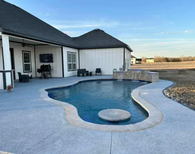 A house with a large swimming pool in front of it