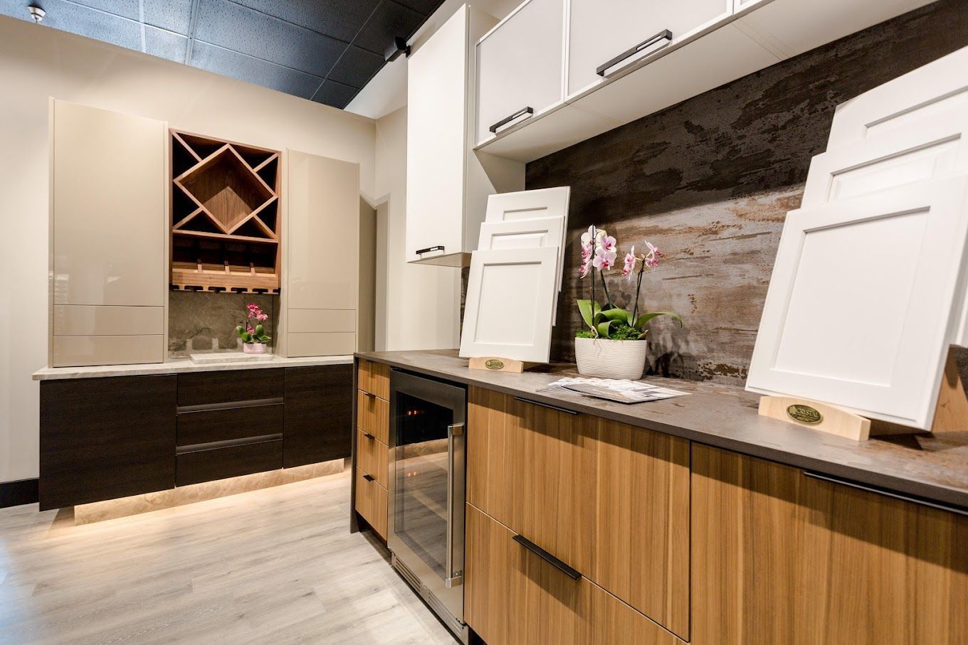 A kitchen with wooden cabinets and white cabinets