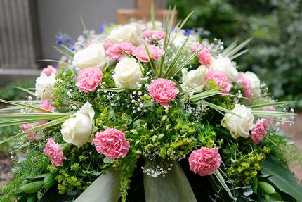 A bouquet of pink and white flowers is sitting on a table.