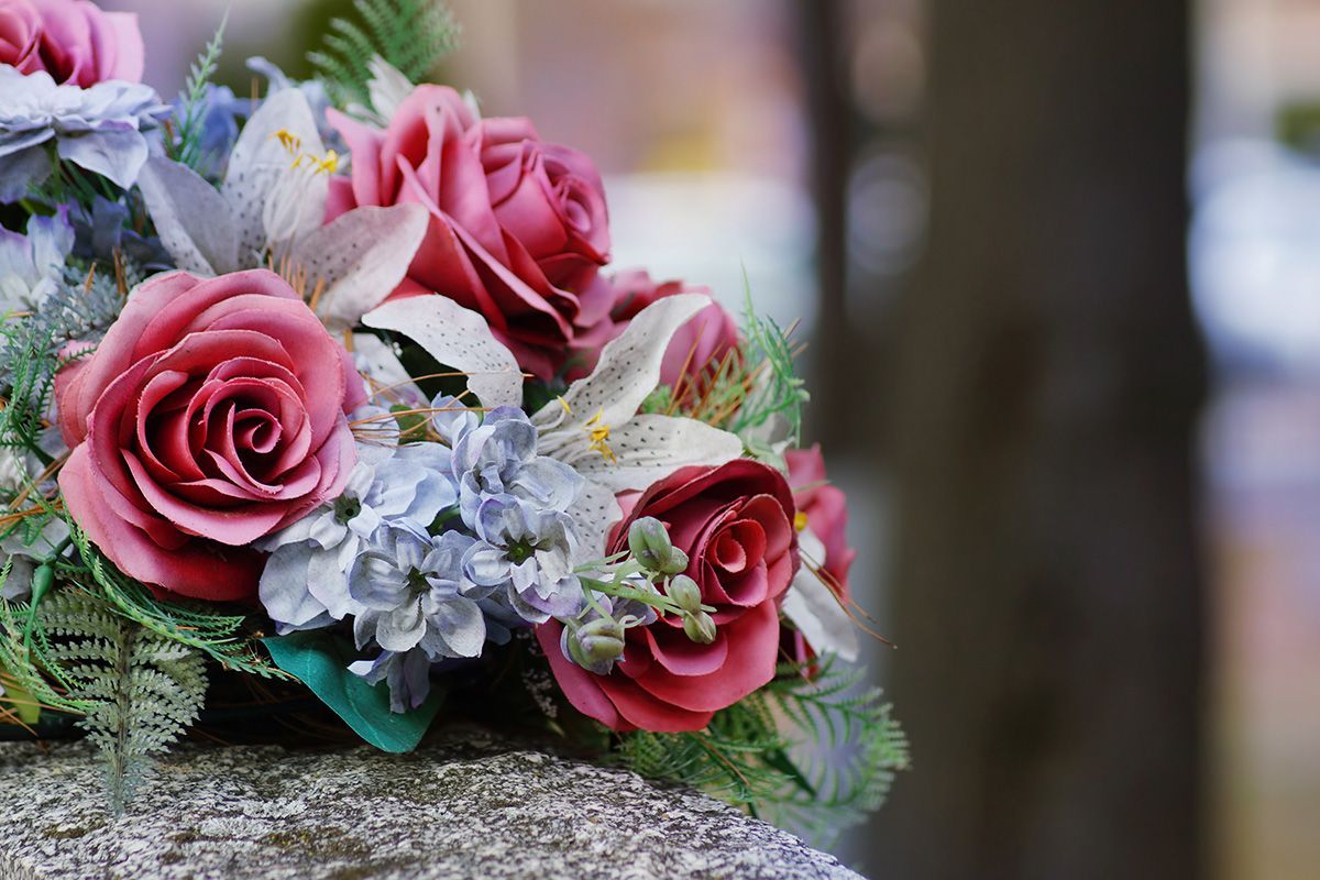 A bouquet of flowers is sitting on top of a rock.