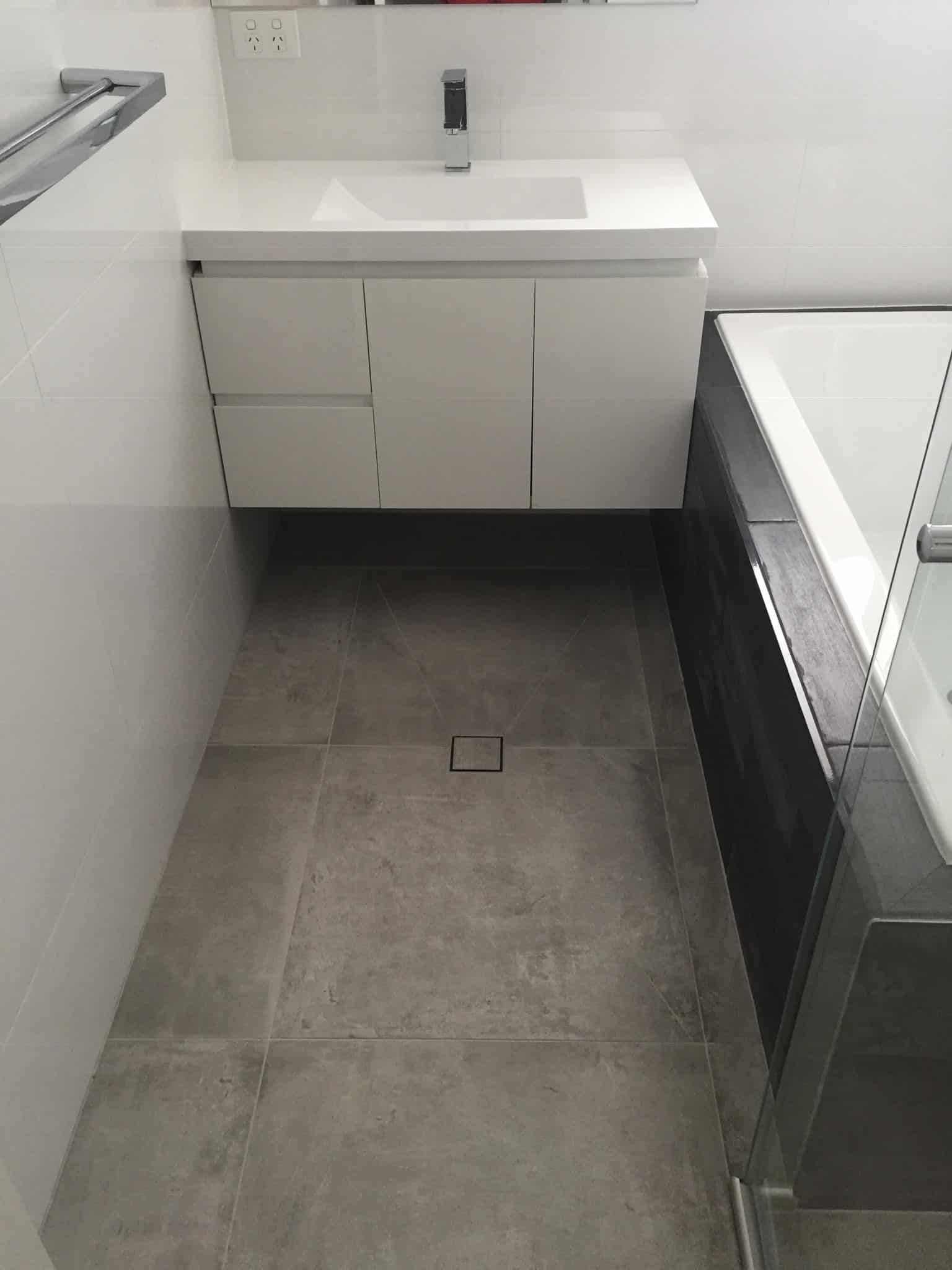 A White Floating Vanity With a Sink — Rectified Edge Tiling & Bathroom Renovations in Jamison Centre, ACT