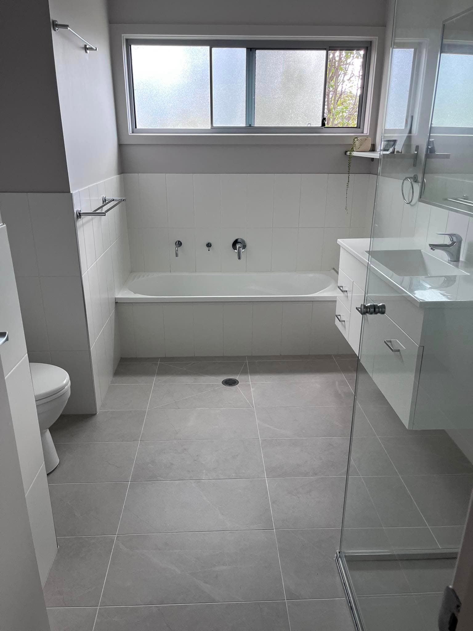 Modern Bathroom With Grey Floor Tiles — Rectified Edge Tiling & Bathroom Renovations in Jamison Centre, ACT
