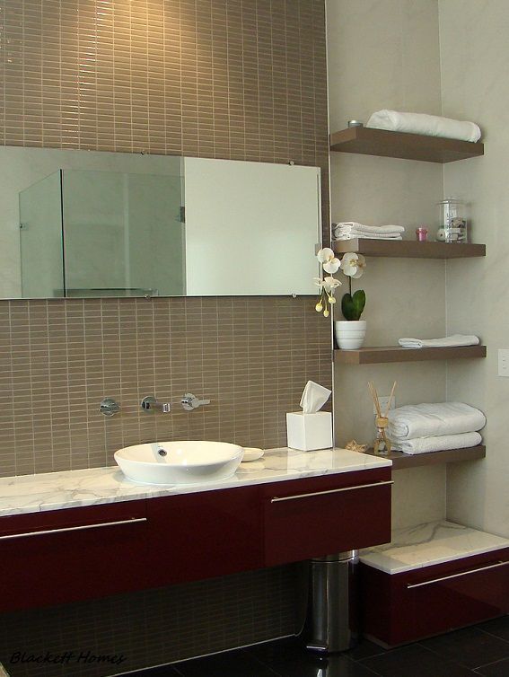 Modern bathroom with floating shelves, white sink, red vanity, and tile wall. — Rectified Edge Tiling & Bathroom Renovations in Batemans Bay, NSW
