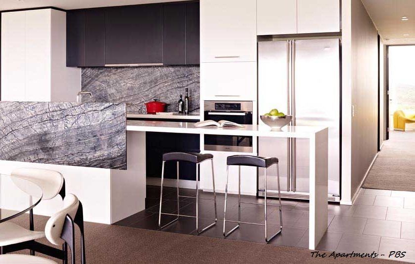 Modern kitchen with white and dark grey cabinets, stainless steel appliances, breakfast bar with stools. — Rectified Edge Tiling & Bathroom Renovations in Fyshwick, ACT