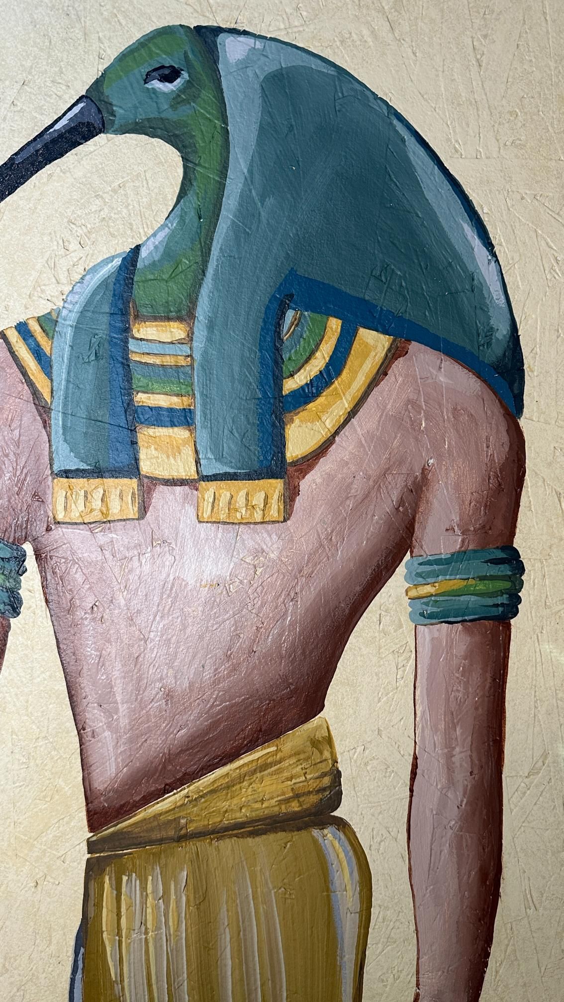 Egyptian god Thoth with ibis head, painted in blue, green, and gold, against a gold background.