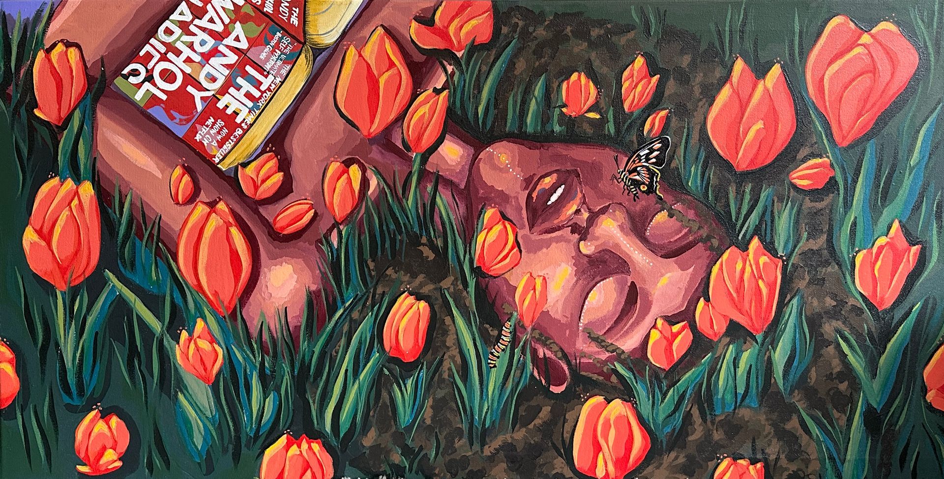 A person lying in a field of orange tulips, reading 