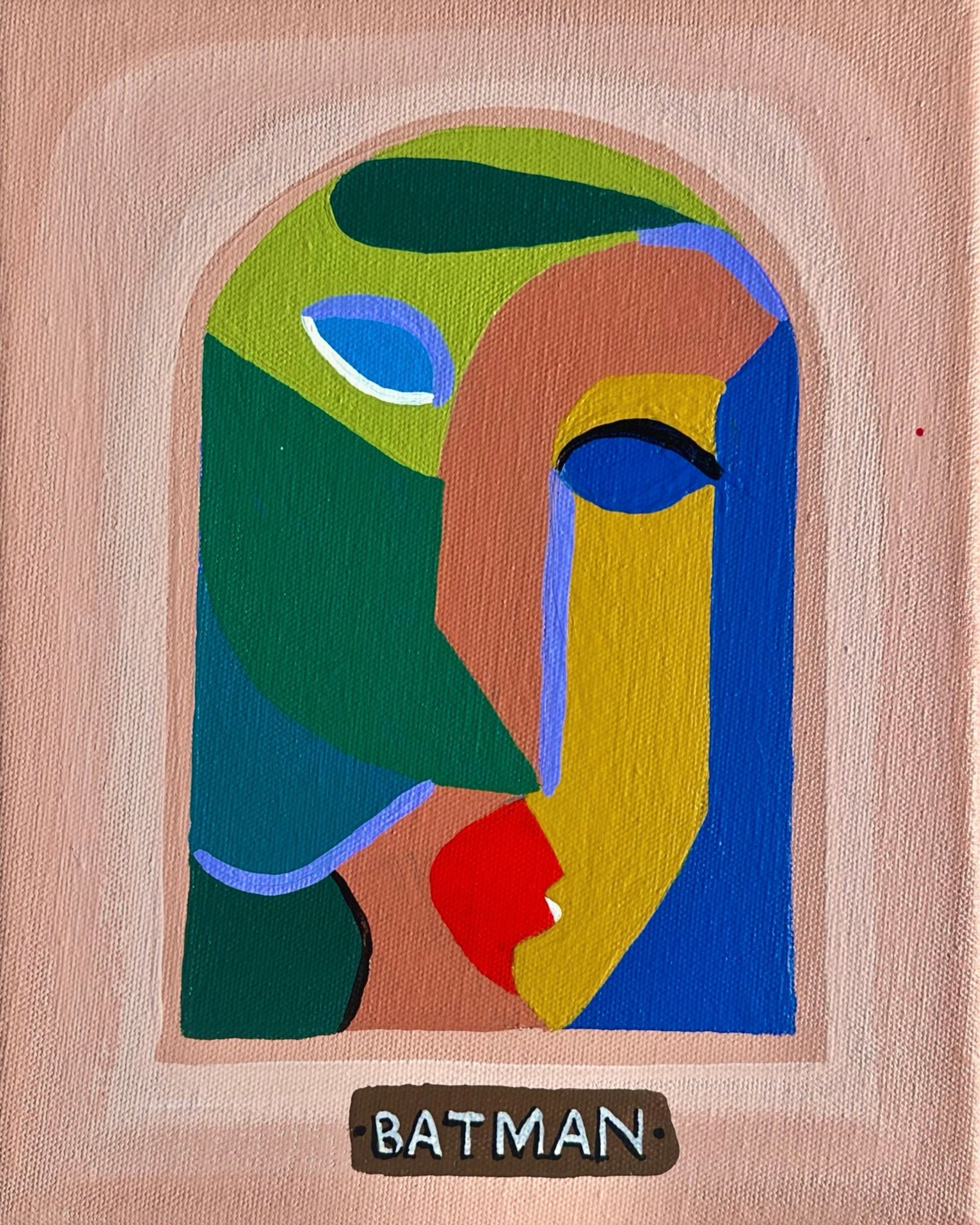 Abstract cubist-style Batman face. Green, blue, and yellow shapes compose the face, with a red mouth.