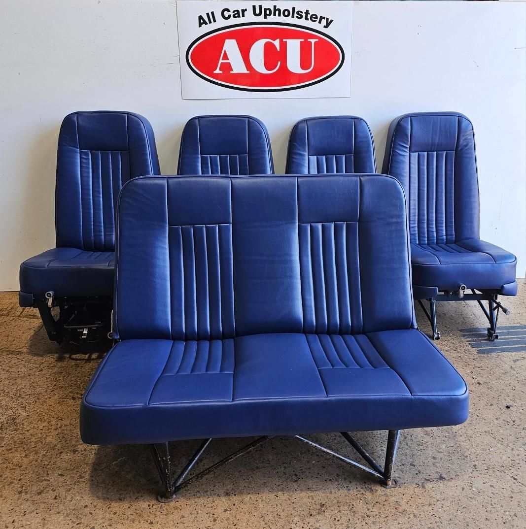 A Group Of Blue Seats Are Sitting In Front Of A Sign That Says ACU — All Car Upholstery In Pinelands, NT