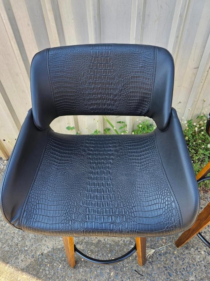 A Black Leather Bar Stool With A Wooden Frame Is Sitting On The Ground — All Car Upholstery In Pinelands, NT