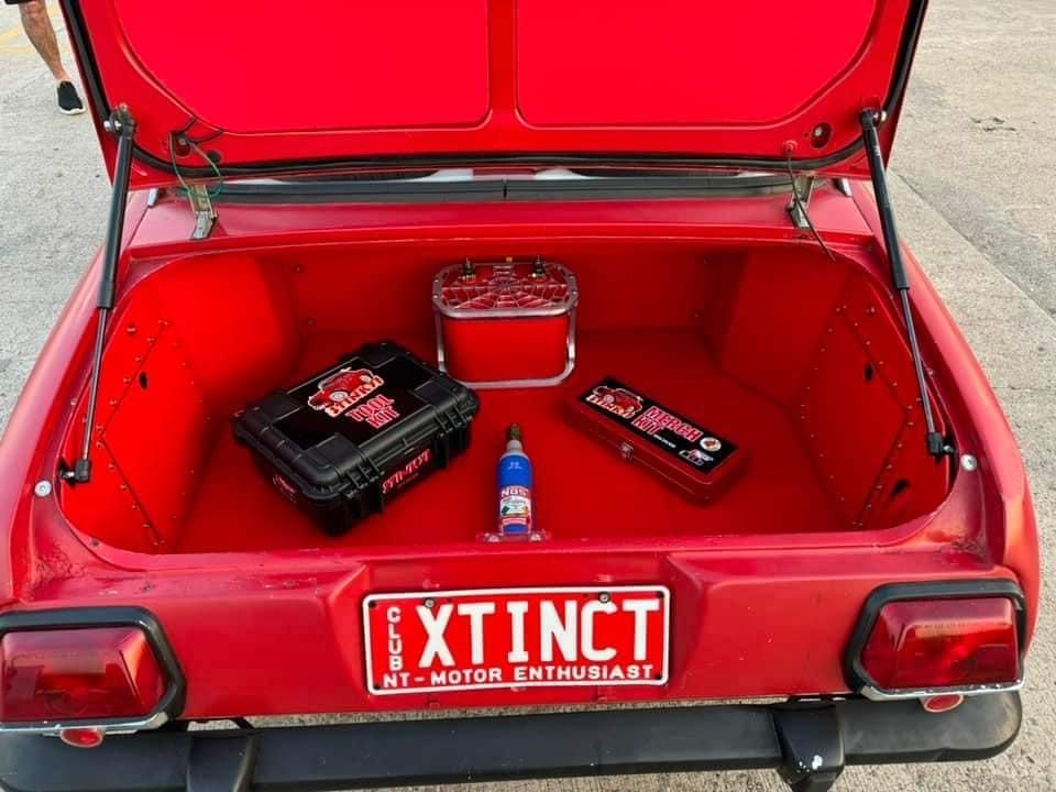 A Red Car With A License Plate That Says Extinct — All Car Upholstery In Pinelands, NT