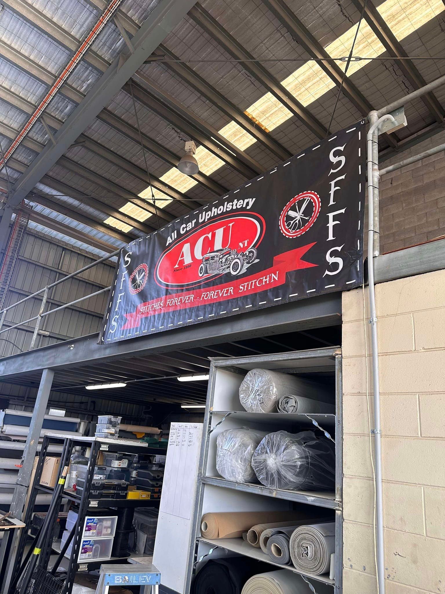 A Red Car Is Parked In A Parking Lot In Front Of A Building — All Car Upholstery In Pinelands, NT