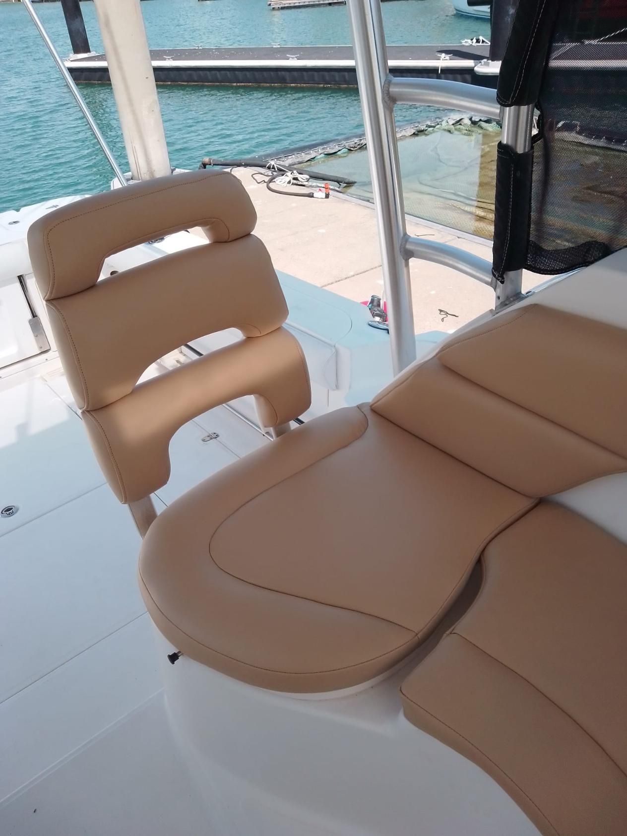 A Chair On A Boat With A Dock In The Background — All Car Upholstery In Pinelands, NT