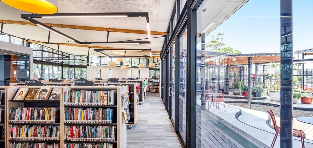 The inside of a library with lots of shelves with books — Commercial Painting Group in Kembla Grange, NSW