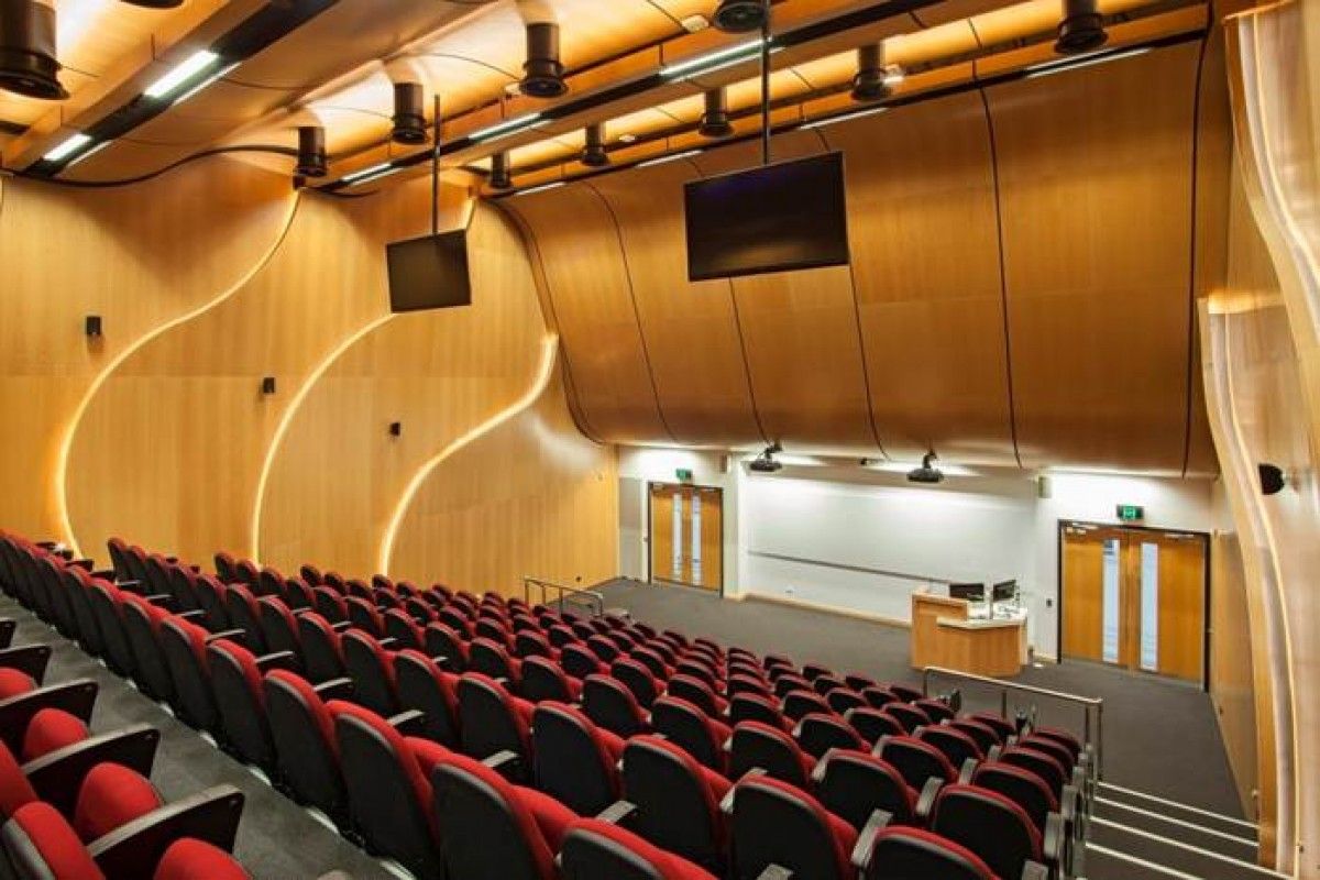 A lecture theatre with lots of chairs and a stage — Commercial Painting Group in Kembla Grange, NSW