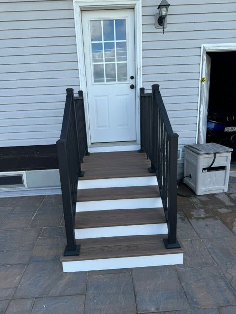 A set of stairs leading up to the front door of a house