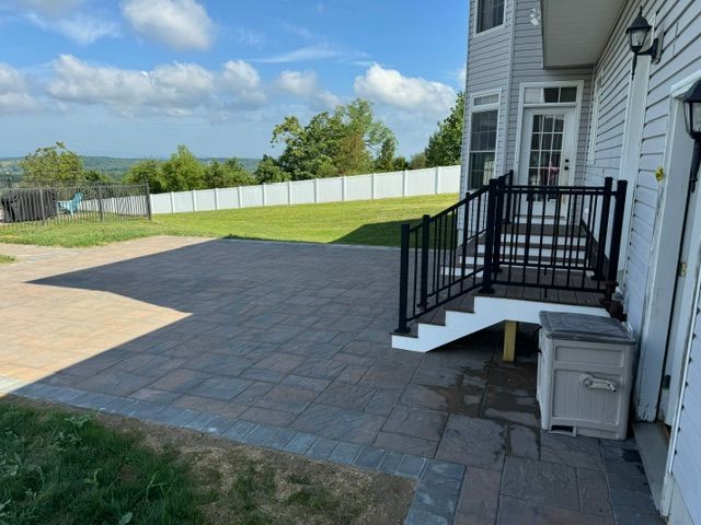 A house with a patio and stairs in front of it.