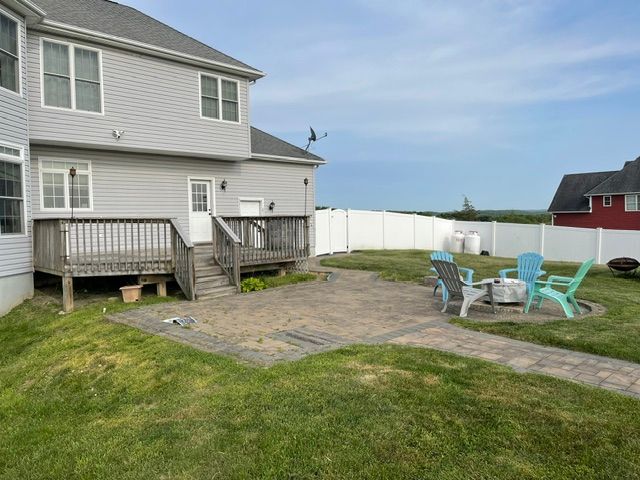 There is a fire pit in the backyard of a house.