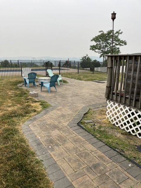 A patio with a table and chairs on it
