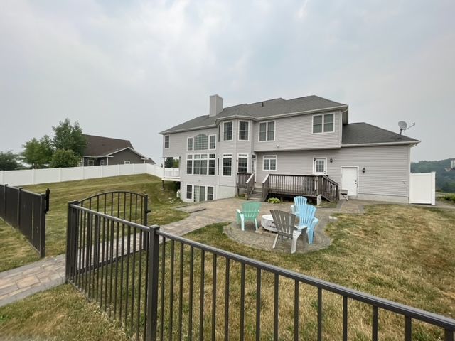 A large house with a fire pit in the backyard