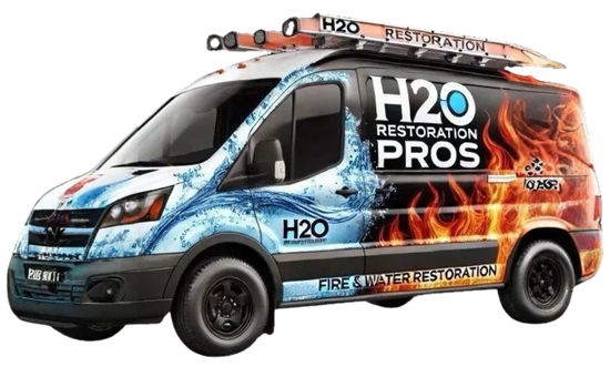 A h2o restoration pros van with a ladder on top of it.