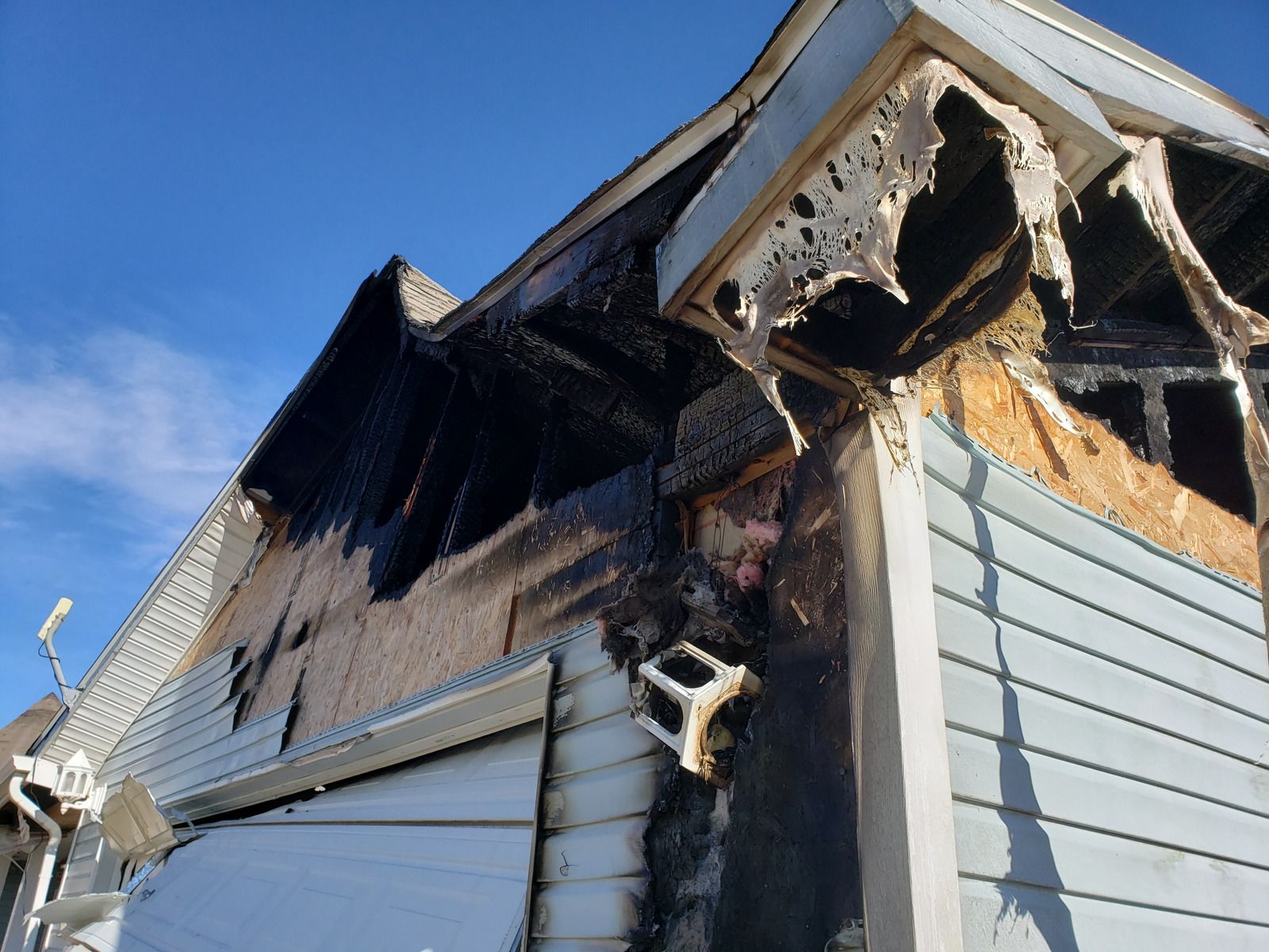 The side of a house that has been damaged by a fire.
