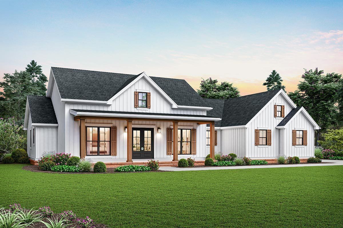 A white house with a porch and a chimney 