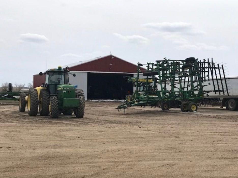 A white house with a porch and a chimney