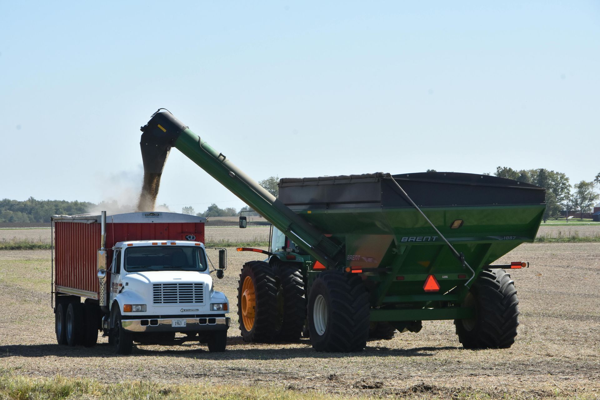 A white house with a porch and a chimney