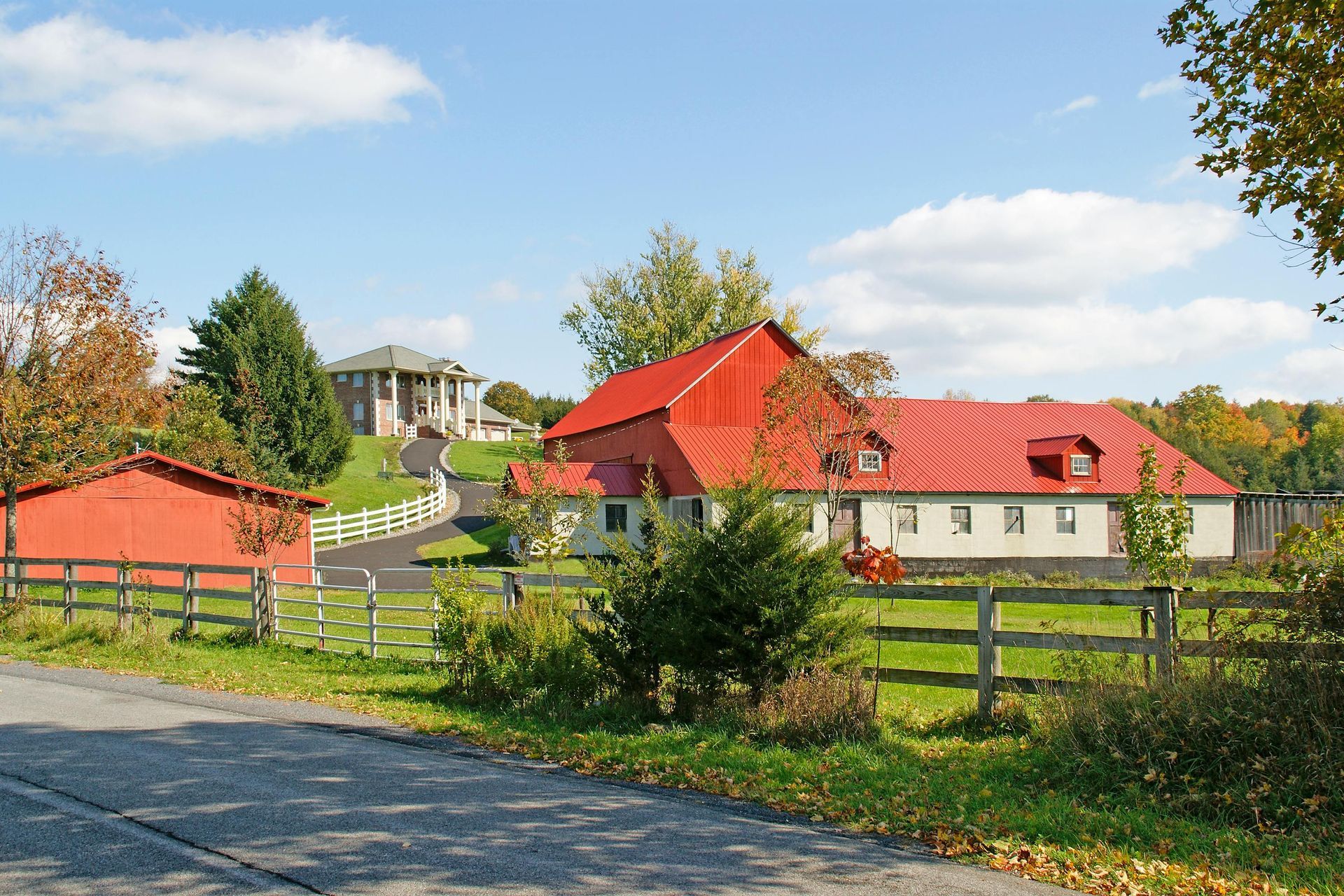 A white house with a porch and a chimney