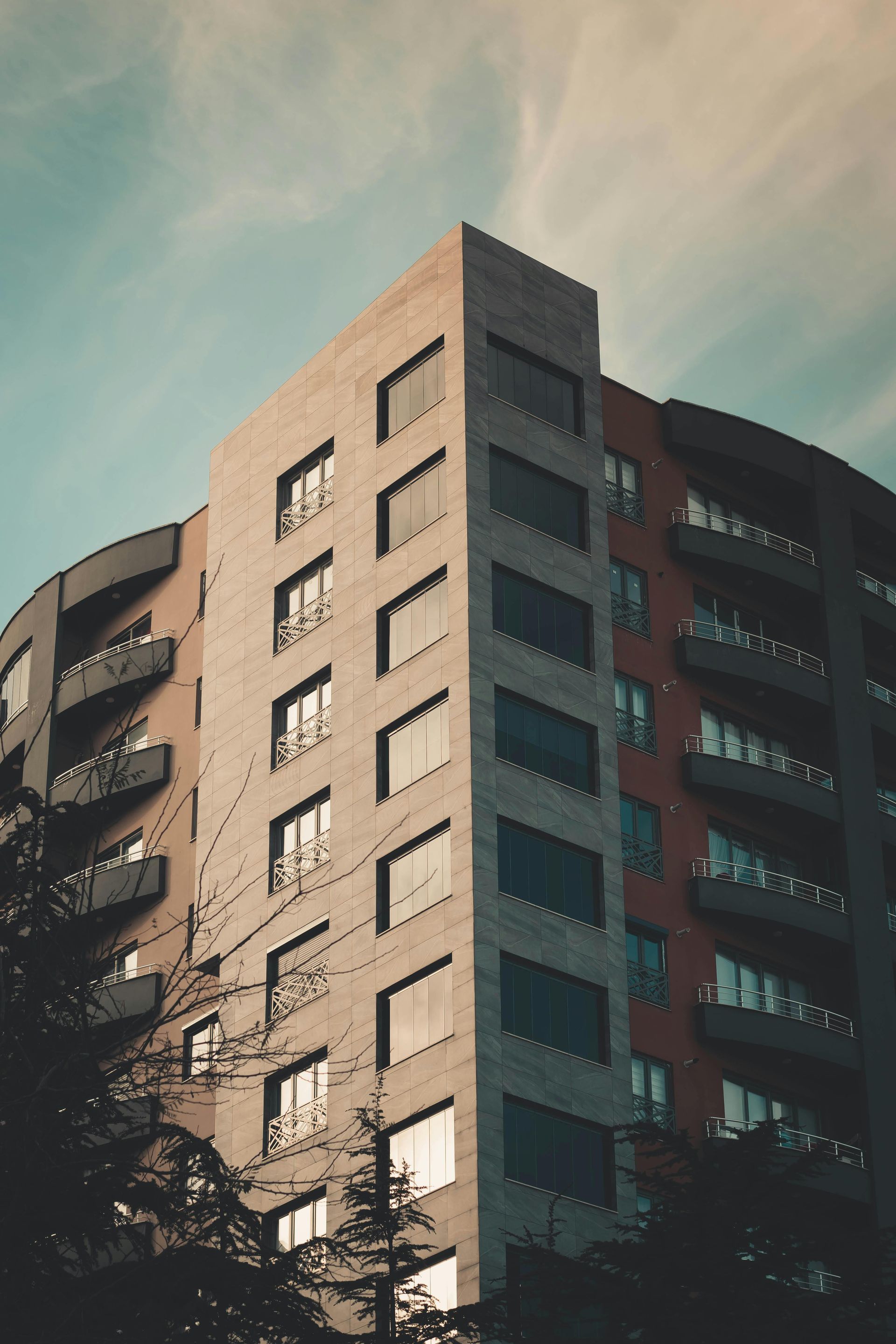Two young boys are laying on the grass and talking to each other.