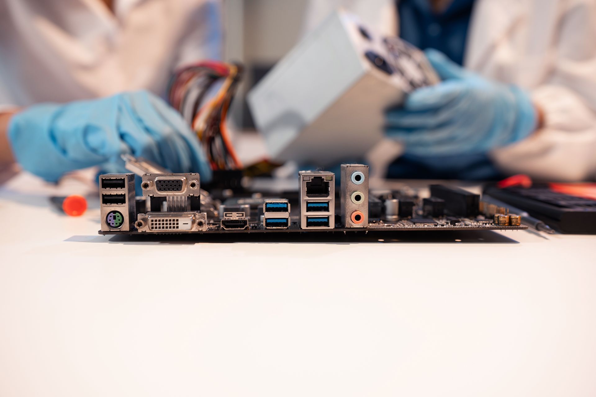 A woman is sitting next to a trailer holding a baby.