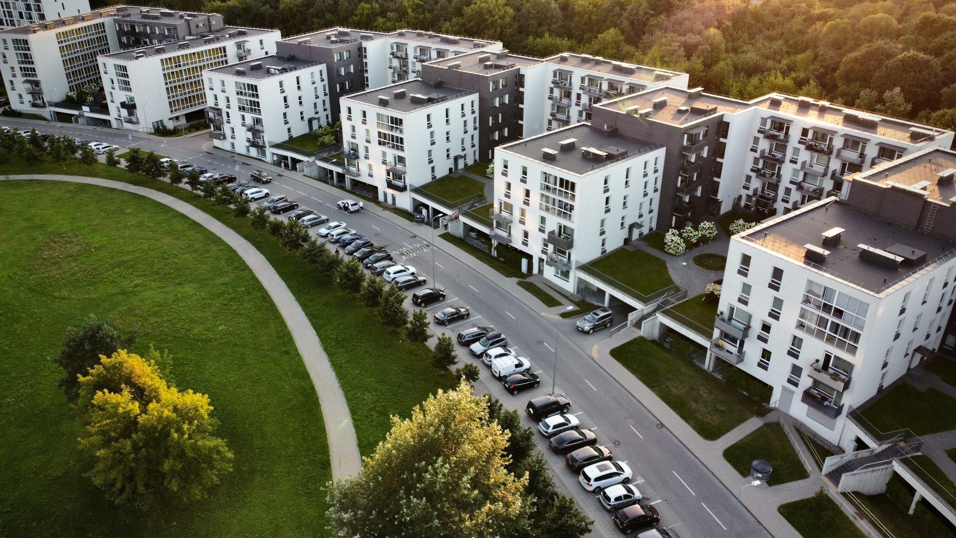 Two young boys are laying on the grass and talking to each other.