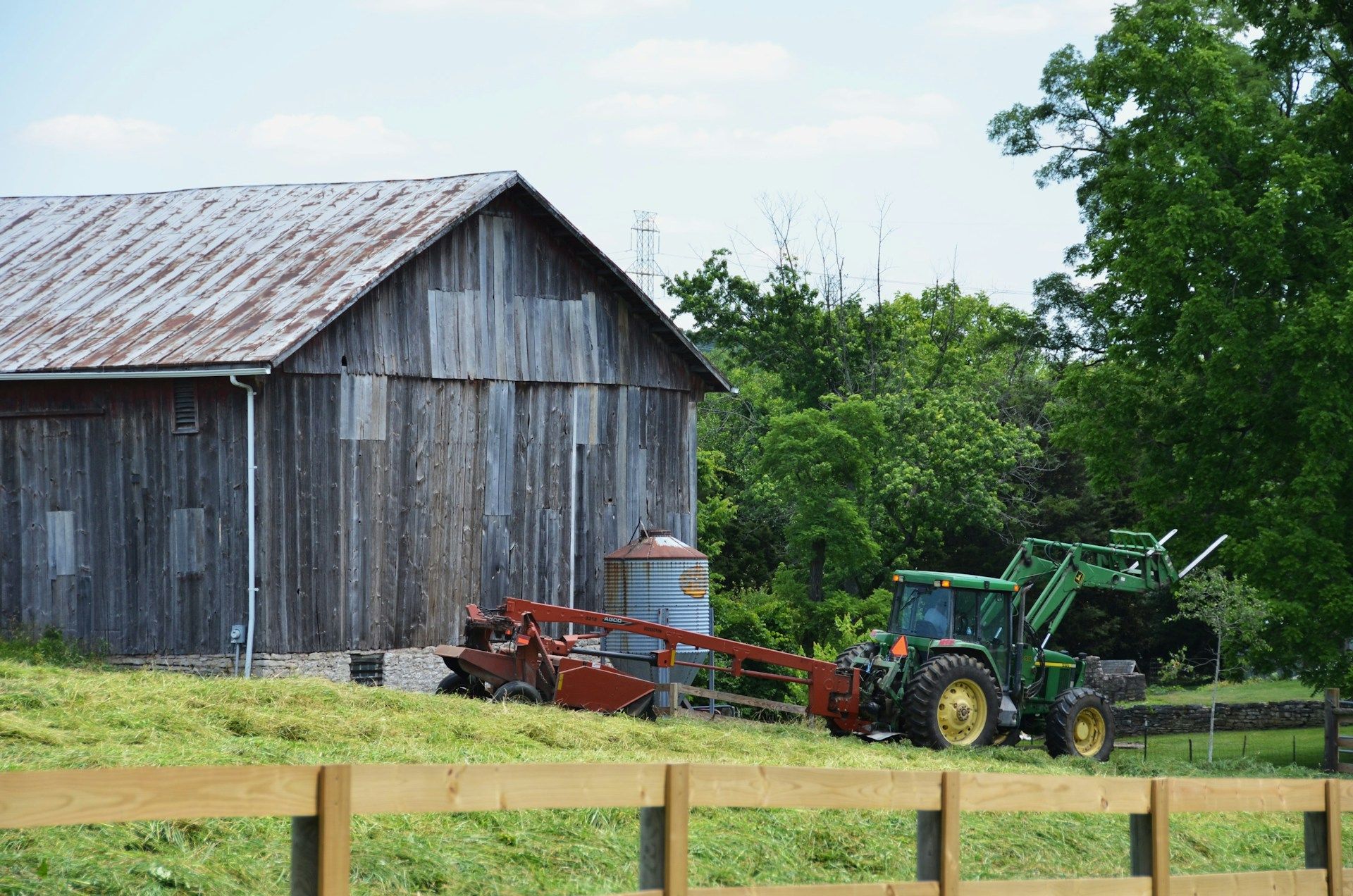 Two young boys are laying on the grass and talking to each other.