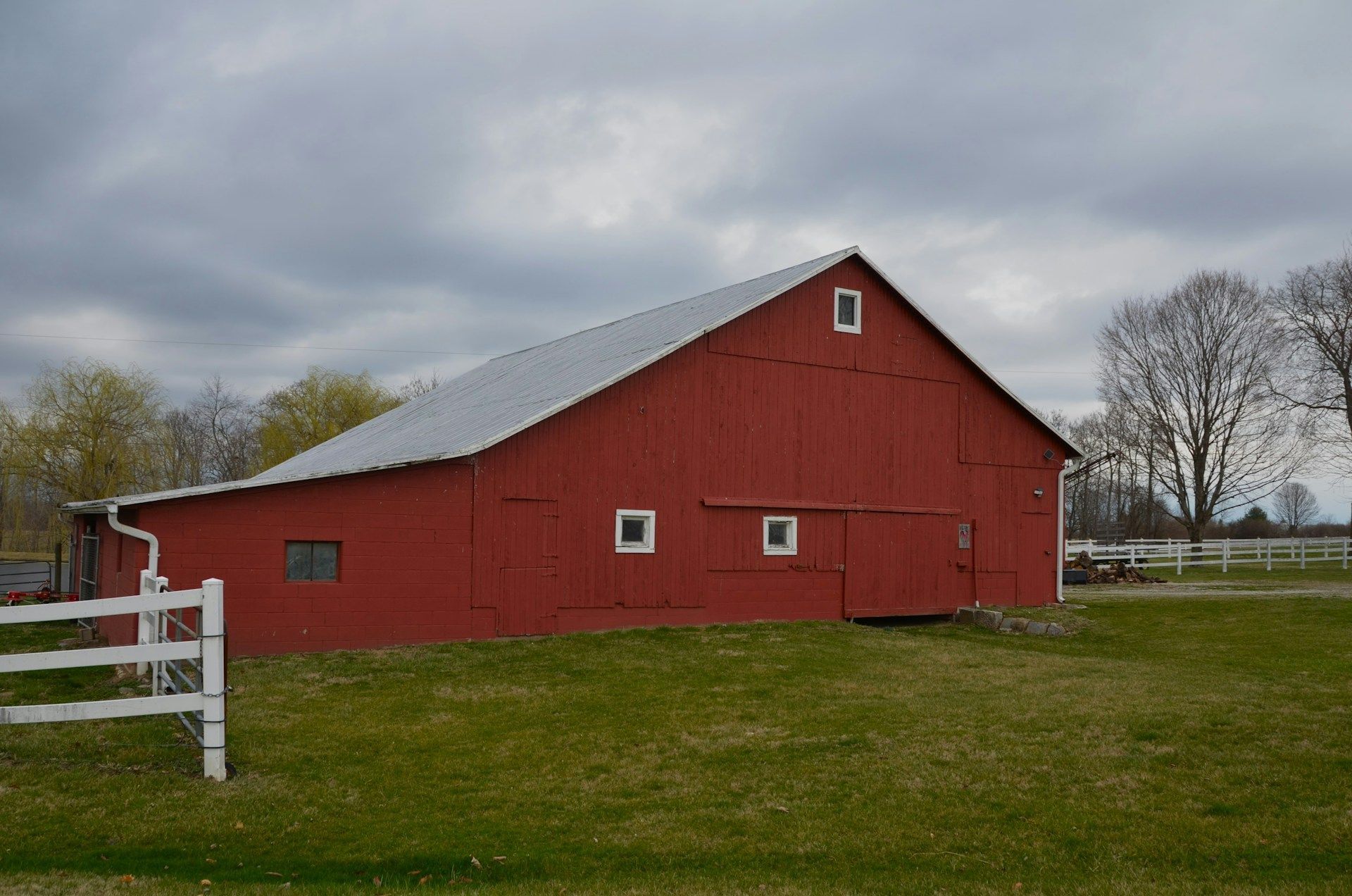 Two young boys are laying on the grass and talking to each other.