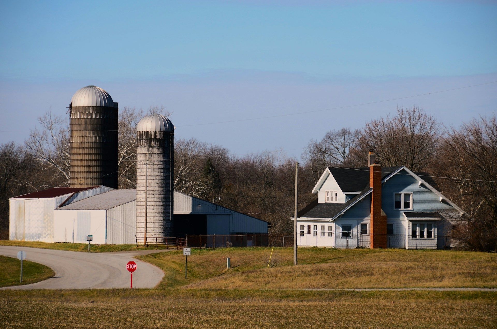 A white house with a porch and a chimney