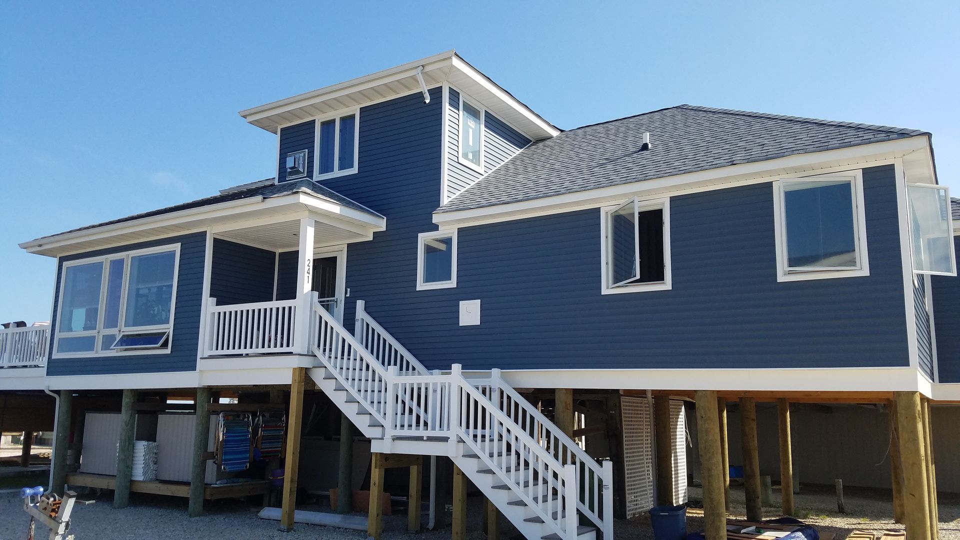 A large blue house with stairs leading up to it