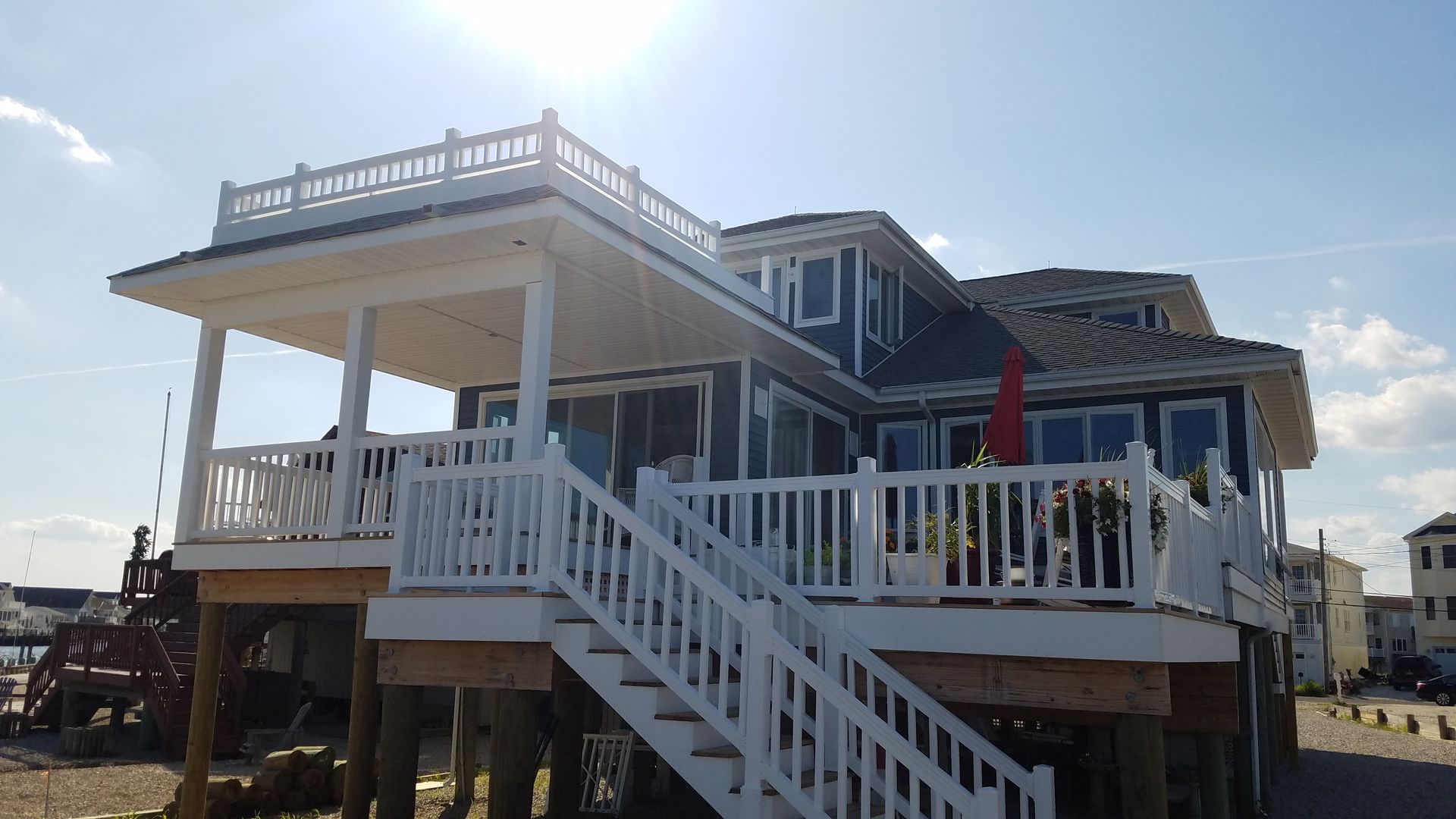 A large house with a large deck and stairs leading up to it.