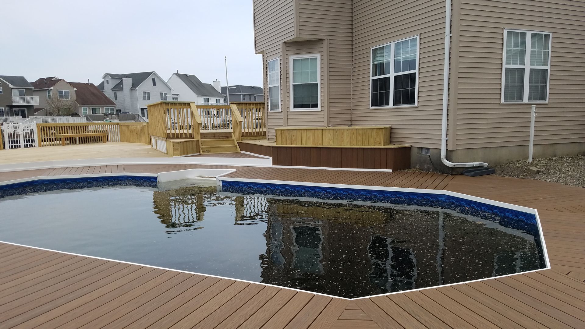 A large house with a swimming pool in front of it