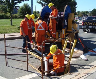 repairmen fixing a sewer