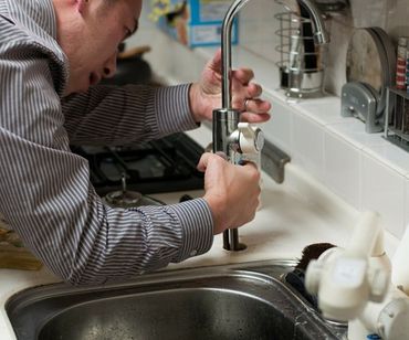 plumber fixing a tap