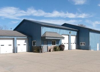 A large blue building with white garage doors