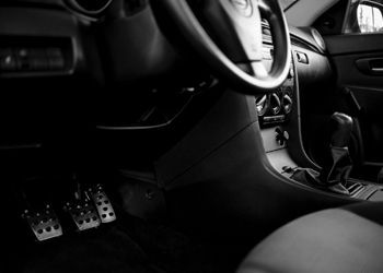 A black and white photo of the interior of a car.