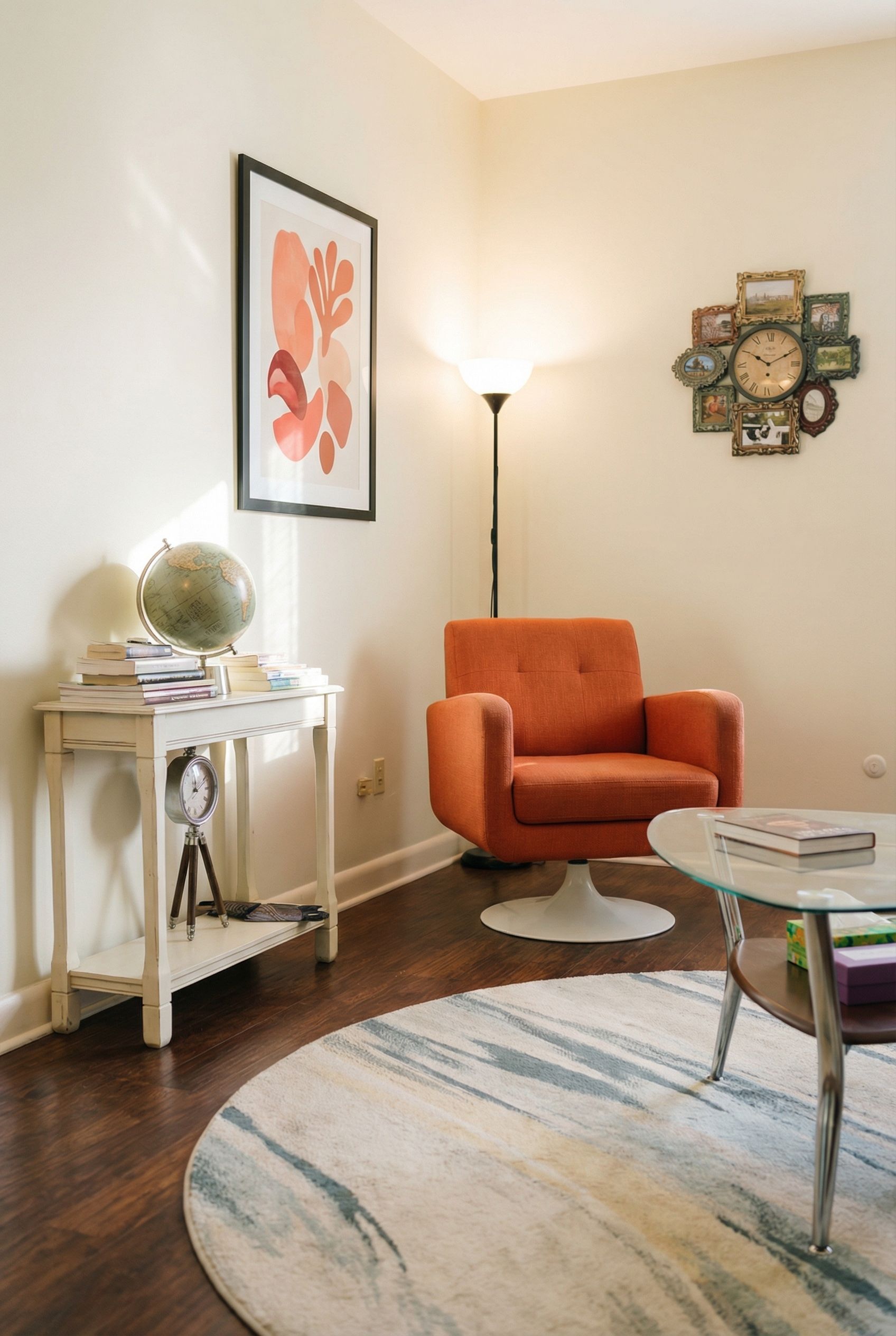 Cozy reading nook with orange chair, round rug, art, and side table with globe.