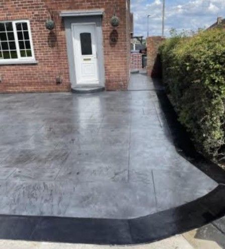 grey paving stone pattern imprinted driveway in Nottingham with tarmac edging