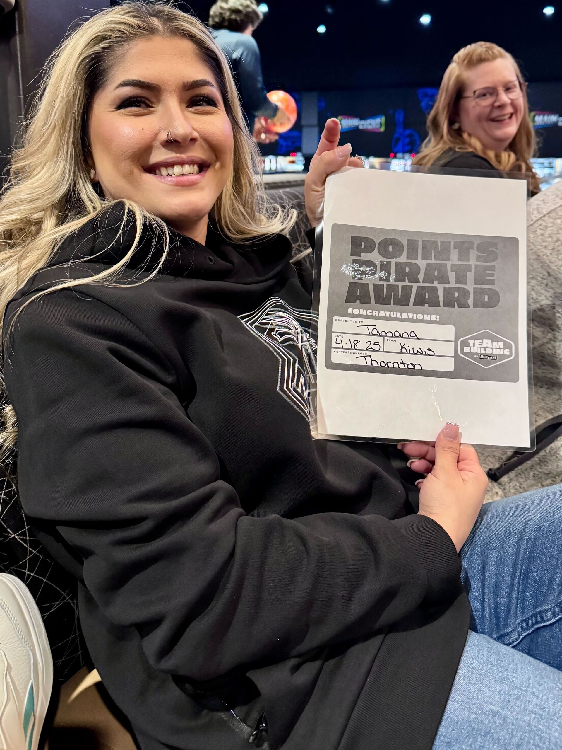 Woman smiles, holding 