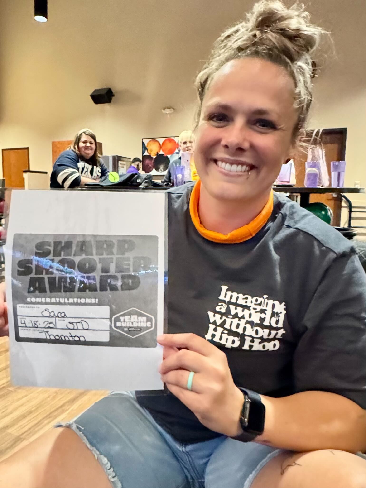 Woman smiling, holding 