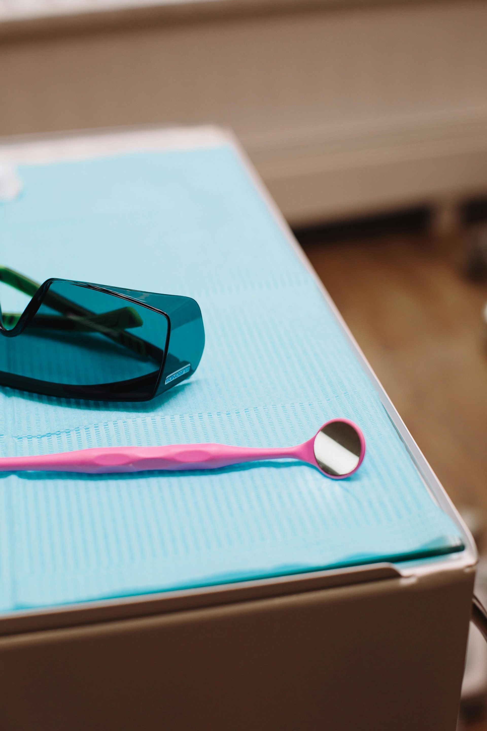 Financial advisor showing phone to senior couple at table with laptop and paperwork.