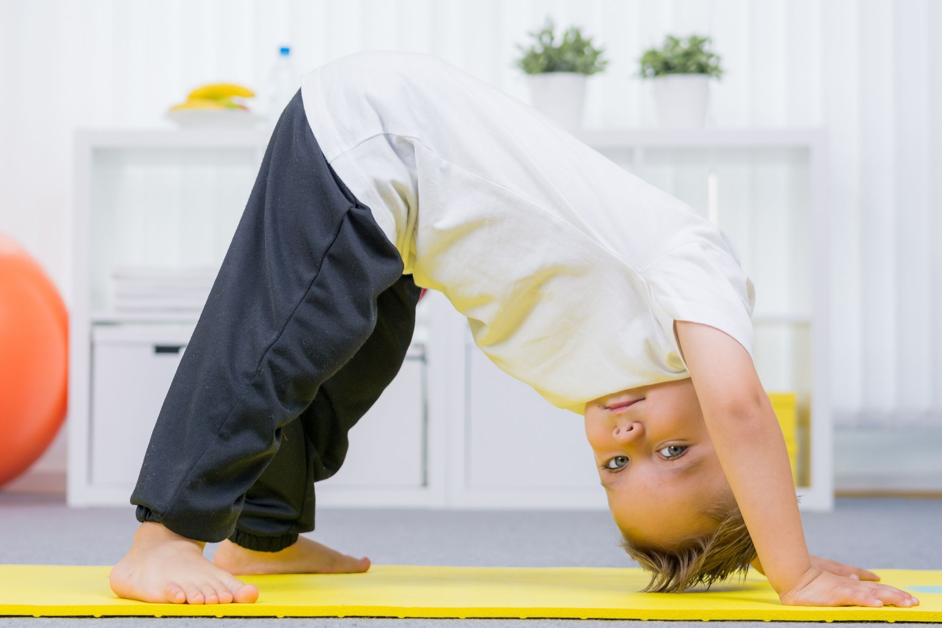 Toddler taking early steps with support