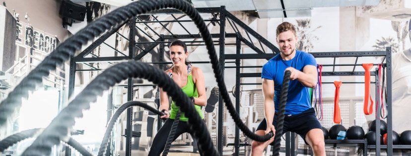 two people working out with ropes